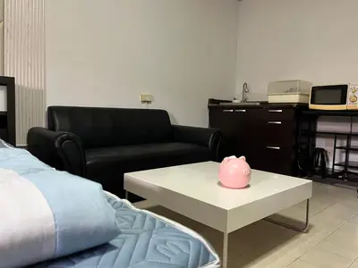 a living room with a couch and a pink pig on a table at Impact Arena C5 by Jintana in Thung Si Kan