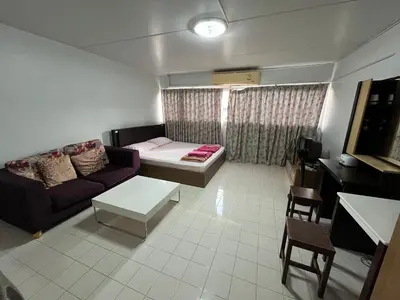 a living room with a couch and a table at Impact Arena C5 by Jintana in Thung Si Kan