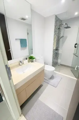 a bathroom with a sink and a toilet and a shower at Bright & Green apartment on BTS Thonglor in Bangkok