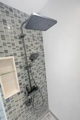 a shower with a shower head in a bathroom at Bright & Green apartment on BTS Thonglor in Bangkok
