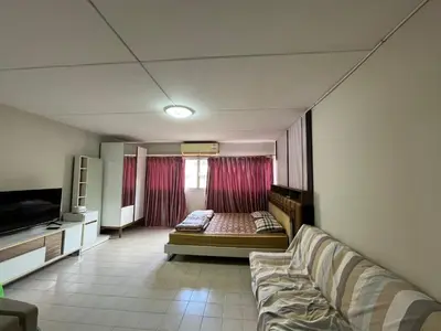 a living room with a couch and a window at Impact Arena C9 by Jintana in Thung Si Kan