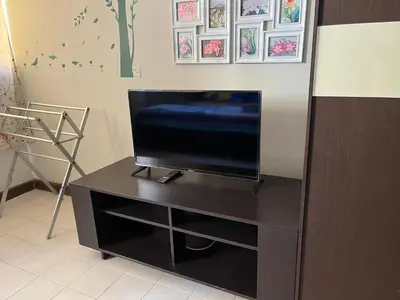 a flat screen tv sitting on top of a black cabinet at Impact Arena C9 by Jintana in Thung Si Kan