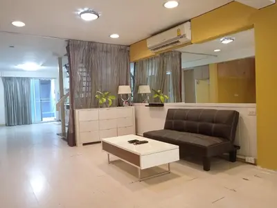 a living room with a couch and a coffee table at Casa Nicola BKK in Ban Na Song