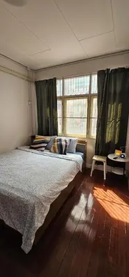 a bedroom with a large bed and a window at Casa Nicola BKK in Ban Na Song