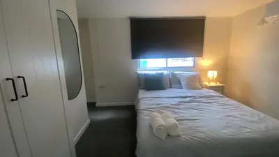 a bedroom with a bed with white shoes on it at Sawasdee Bangkok Condo Modern 2BR BTS Srinakarin38 connect Sukhumvit Route 20mins Aiport and 15mins Sukhumvit Line in Bangna