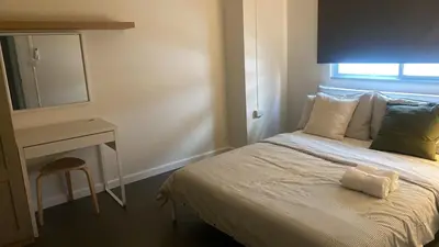a bedroom with a bed and a desk and a mirror at Sawasdee Bangkok Condo Modern 2BR BTS Srinakarin38 connect Sukhumvit Route 20mins Aiport and 15mins Sukhumvit Line in Bangna