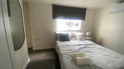 a bedroom with a bed with two towels on it at Sawasdee Bangkok Condo Modern 2BR BTS Srinakarin38 connect Sukhumvit Route 20mins Aiport and 15mins Sukhumvit Line in Bangna