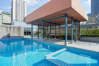 a swimming pool with a pavilion in a city at Dazzle Residence ByPinny2 in Bangkok