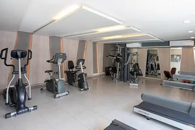 a gym with a bunch of exercise equipment in a room at Dazzle Residence ByPinny2 in Bangkok