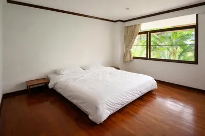 a bedroom with a white bed and a window at Big 3 bedroom apartment Asoke in Bangkok