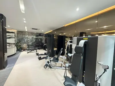 a gym with rows of treadmills and exercise bikes at Fynn Bangkok Asoke Condo in Bangkok
