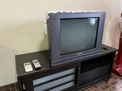a television on a table with a remote control at Impact Arena C4 by Jintana in Ban Bang Phang