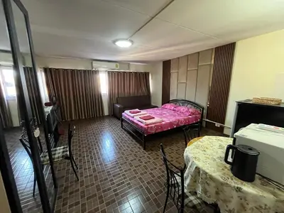 a room with a bed and a table and chairs at Impact Arena C4 by Jintana in Ban Bang Phang