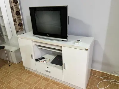 a tv sitting on top of a white entertainment center at Impact Arena C3 by Jintana in Ban Bang Phang