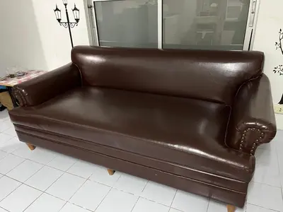 a brown leather couch sitting in a room at Impact Arena C3 by Jintana in Ban Bang Phang