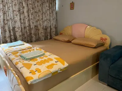 a small bedroom with a bed with a blanket on it at Impact Arena C3 by Jintana in Ban Bang Phang