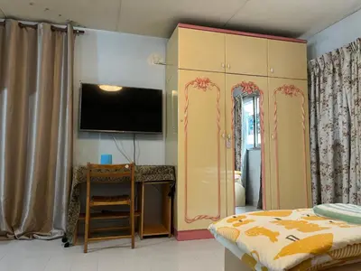 a bedroom with a bed and a desk and a tv at Impact Arena C3 by Jintana in Ban Bang Phang