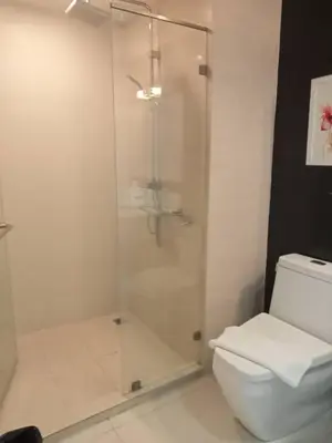 a bathroom with a shower and a toilet at Avatar Suites Hotel - SHA Extra Plus in Bangkok
