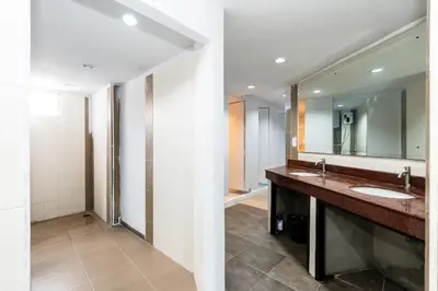 a bathroom with two sinks and a large mirror at xx The Hidden Khaosan in Bangkok