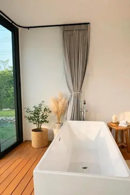 a white bath tub in a room with a window at Feel Private Pool Villa in Ban Lam Praya Phai Rua