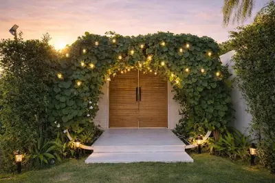 an entrance to a house with an arch with lights at Feel Private Pool Villa in Ban Lam Praya Phai Rua