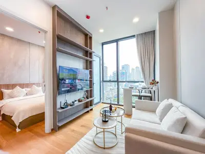 a bedroom with a bed and a living room at Luxe City Condo in Central Bangkok in Pratunam