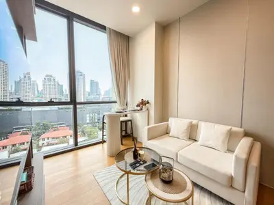 a living room with a couch and a table at Luxe City Condo in Central Bangkok in Pratunam