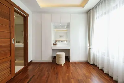 a hallway with white walls and a white sink at Bhumidol Home near Don Muang Airport in Lak Si