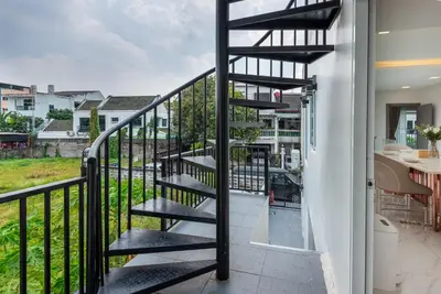 a staircase leading to the balcony of a house at Bangkoks most beautiful modern villa centre in Bangkok
