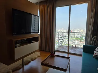 a living room with a television and a large window at Chaophraya River high-rise river view apartment direct access to iconsiam Siam Square Chinatown 0 distance from BTS subway exit direct to Sathorn Silom Road Siam Square in Bangkok