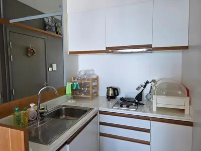 a kitchen with a sink and a counter top at Chaophraya River high-rise river view apartment direct access to iconsiam Siam Square Chinatown 0 distance from BTS subway exit direct to Sathorn Silom Road Siam Square in Bangkok
