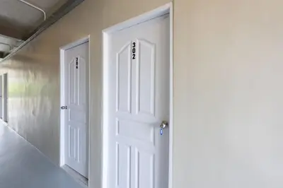 an open white door in a room with stairs at ดอนเมือง 303 Near DMK Airport BTS Wat PhraSi in Bang Khen