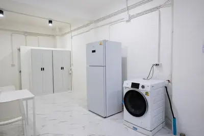 a laundry room with a washing machine and a refrigerator at ดอนเมือง 303 Near DMK Airport BTS Wat PhraSi in Bang Khen