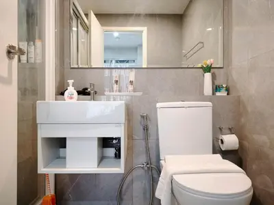 a bathroom with a white toilet and a sink at Phahonyothin 35 Cozy 1BR Near BTS Chatuchak in Sathani Bang Khen