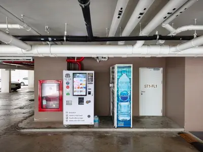 a parking lot with two vending machines and a water machine at Phahonyothin 35 Cozy 1BR Near BTS Chatuchak in Sathani Bang Khen