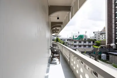 a chair sitting on the balcony of a building at ดอนเมือง 306 Near DMK Airport BTS Wat PhraSi in Bang Khen