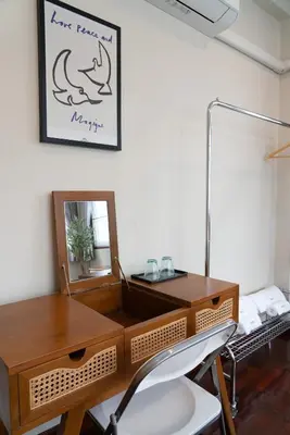 a dressing table with a mirror and a chair at Sadhu10BedBake in Bangkok