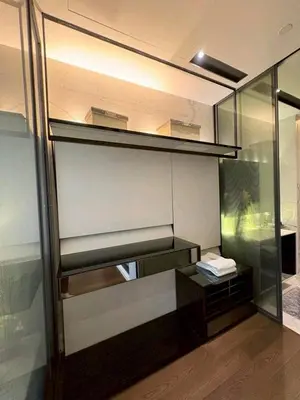 a room with a shelf and a table in it at The Bangkok Thonglor in Bangkok