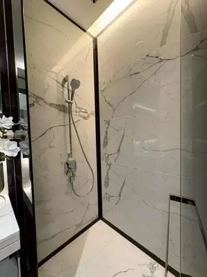 a bathroom with a shower with a glass door at The Bangkok Thonglor in Bangkok