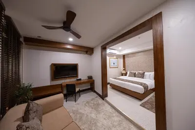 a bedroom with a bed and a flat screen tv at Casa Le Damuz in Bangkok