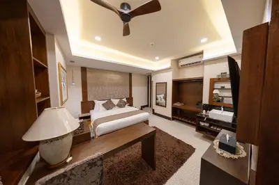 a bedroom with a bed and a ceiling fan at Casa Le Damuz in Bangkok