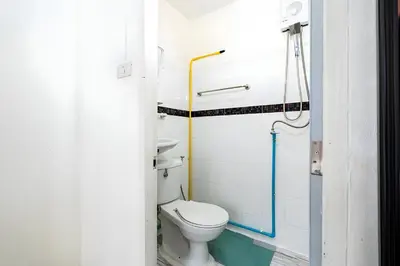 a bathroom with a toilet and a shower at XX Oh My Nap Sukhumvit 3 - นานาเหนือ in Makkasan
