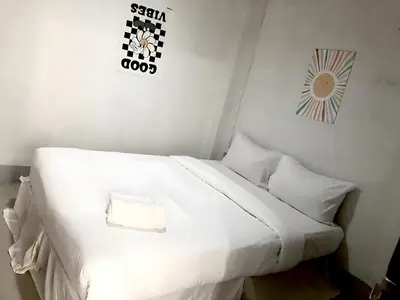 a white bed with white sheets and pillows in a room at XX Oh My Nap Sukhumvit 3 - นานาเหนือ in Makkasan