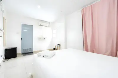 a white bathroom with a sink and a television at XX Oh My Nap Sukhumvit 3 - นานาเหนือ in Makkasan