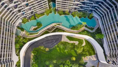 an overhead view of a pool in the middle of two tall buildings at Idea Labs Luxury Condo Coworking spaces in Ban Khlong Samrong
