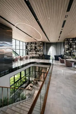 a library with a staircase and chairs and books at Idea Labs Luxury Condo Coworking spaces in Ban Khlong Samrong