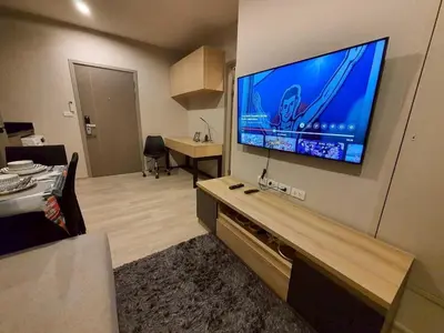 a living room with a large flat screen tv on a wall at Idea Labs Luxury Condo Coworking spaces in Ban Khlong Samrong