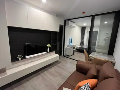 a living room with a couch and a flat screen tv at Wutthakat high-rise exterior view room in Bangkok