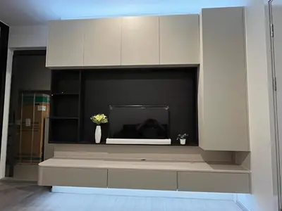 a living room with a fireplace with white cabinets at Wutthakat high-rise exterior view room in Bangkok