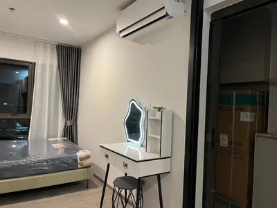 a room with a bed and a chair and a desk at Wutthakat high-rise exterior view room in Bangkok